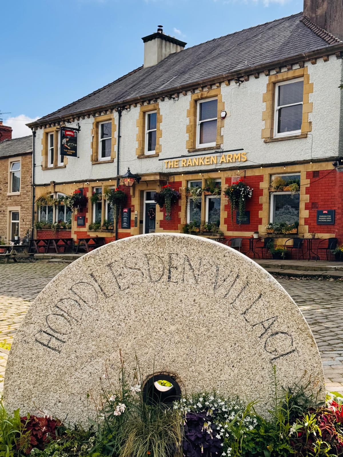 The Hoddlesden Village millstone in front of The Ranken Arms